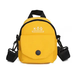 Minimalist bright yellow canvas crossbody bag with black handles and KǑQ logo print