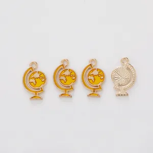 Golden globe charms with yellow enamel world map details for DIY jewelry and keychains