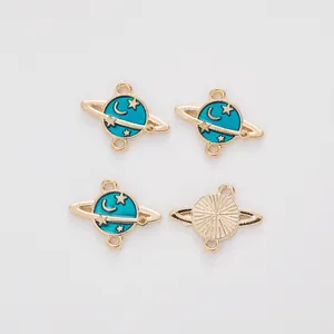 Macro detail of alloy planet charms showing blue enamel stars and golden metal texture