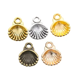 Detail of shell pendants in five metallic finishes with textured stripes for DIY jewelry
