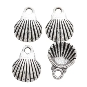 Detail view of four vintage silver shell pendants in zinc alloy with radial stripes