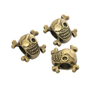 Trois perles de crâne en bronze vintage avec de grands trous pour bijoux et paracord