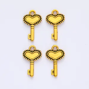 Detailed view of four golden vintage crown key charms for DIY jewelry accessories