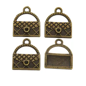 Set of four vintage bronze handbag charms with quilted patterns and circular rings