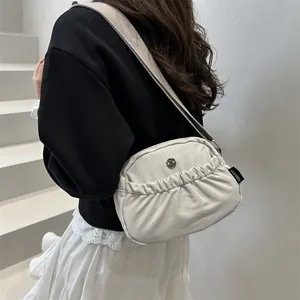 Japanese style nylon crossbody bag with pleated texture and wide strap on model