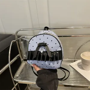Striped mini backpack with black bow and heart print on a modern aesthetic chair