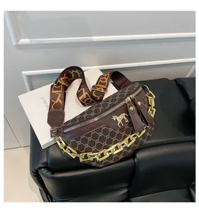 Close-up of vintage brown pattern chest bag with gold chain and horse logo