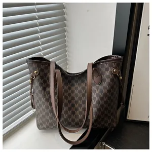 Detailed view of the large capacity dark brown tote bag with M letter monogram pattern