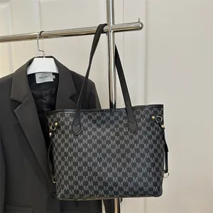 Elegant black monogram tote bag with leather straps and silver M pattern print