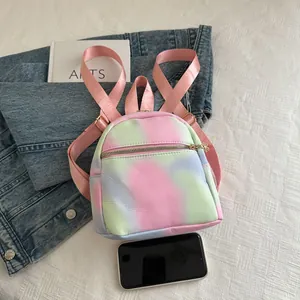 Top view of tie-dye mini backpack with flower zipper puller and pink fabric strap
