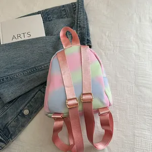 Detail of macaron gradient mini backpack with adjustable pink straps and gold hardware