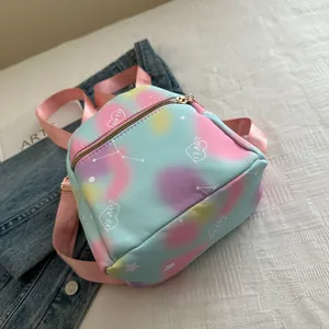 Detail view of mini tie-dye backpack with heart embroidery and pink textile straps