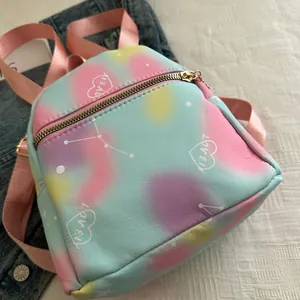 Detail of colorful tie-dye mini backpack with heart graphics and star constellations
