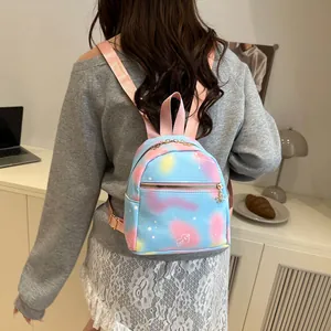 Macro view of blue aurora PU leather mini backpack showing pink straps and love print