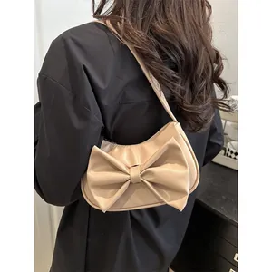 Chic beige butterfly knot shoulder bag for women shown on model for y2k fashion style