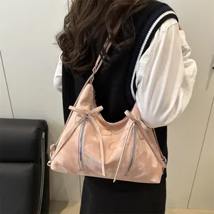Sac bandoulière en similicuir rose avec nœuds décoratifs et deux fermetures éclair argent