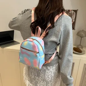 Close-up of mini gradient backpack with star patterns and lovely text on a model back