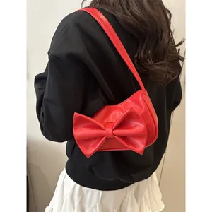 Chic red butterfly bow shoulder bag for women with y2k style and sleek PU leather finish