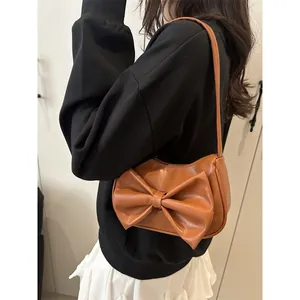 Brown PU leather Y2K shoulder bag featuring a large bow and slim strap for summer wear