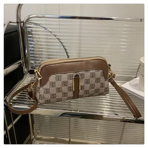 Detailed macro view of monogram canvas texture and leather trim on a vintage crossbody bag
