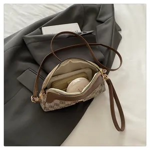 Detail view of checkered crossbody bag interior showing storage for phone and wallet