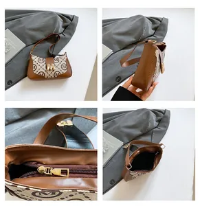 Detailansicht der Vintage-Unterarmtasche mit Monogramm, goldenem M-Verschluss und Reißverschluss