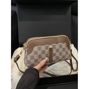 Brown jacquard crossbody bag with T-pattern weave and adjustable leather strap