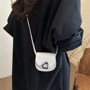 Mini white heart saddle bag for girls with lychee grain leather and silver metal buckle