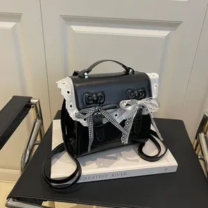 Lace-trimmed black faux leather backpack with bow details and elegant double breasted style