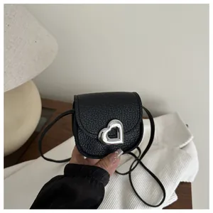 Mini heart-shaped buckle saddle bag in black pebble leather for little girls