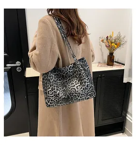 Modern leopard print tote bag styled with a beige coat in a minimalist home setting