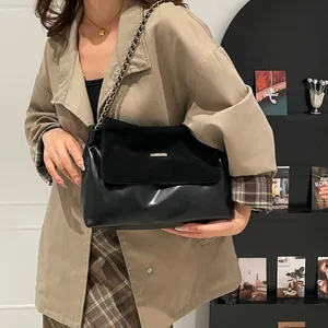 Vintage black chain tote bag with matte suede flap and polished leather texture