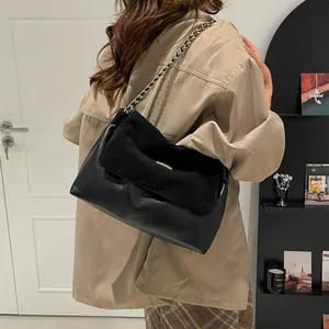 Fashionable black shoulder bag with gold chain strap and elegant flap design