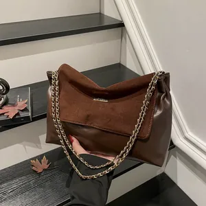 Dark brown large shoulder bag with gold chain strap and mixed leather texture
