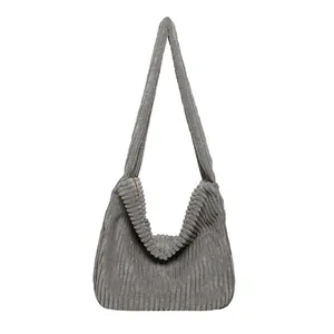 Minimalist grey corduroy hobo shoulder bag with textured fabric and spacious interior