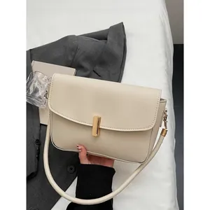 Elegant off-white crossbody shoulder bag with a gold buckle clasp and leather finish