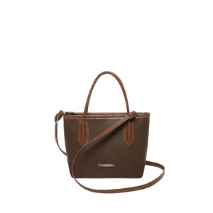 Classic coffee brown leather bucket bag with contrasting light brown handles and strap