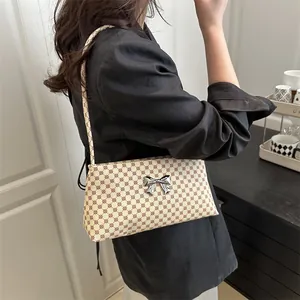 Chic beige shoulder bag with geometric pattern and silver metal bow detail