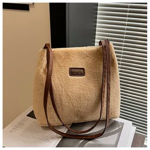 Close-up of fluffy faux fur tote bag with brown leather tag and long shoulder straps