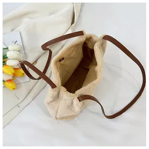 Detail view of the plush tote bag showing inner magnetic buckle and brown lining
