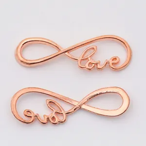 Macro detail of rose gold infinity love pendants for DIY jewelry making and crafts