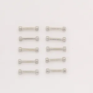 Ten pieces of vintage silver zinc alloy barbell pendants arranged in two neat rows