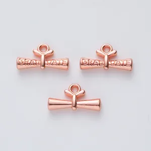 Three rose gold diploma scroll pendants with GRADUATE engraving for DIY jewelry making