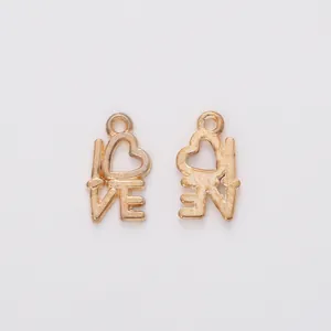 Detail of vintage gold heart-shaped LOVE letter pendants for DIY jewelry making