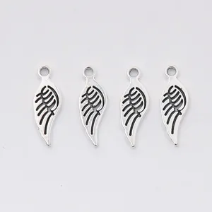Set of four vintage silver zinc alloy wing charms with hollow feather detail for DIY jewelry