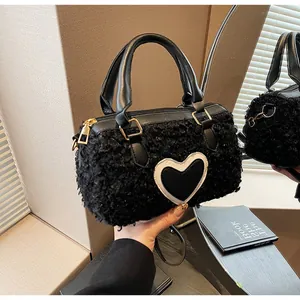 Furry black Boston handbag with heart patch and round leather handles for autumn style