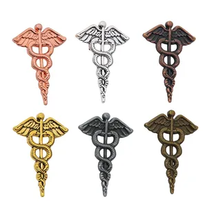 Set of six vintage alloy Caduceus pendants in multiple antique metallic finishes