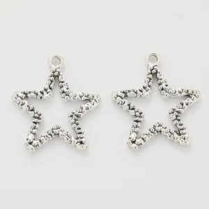 Set of two vintage star-shaped zinc alloy pendants with textured hammered finish