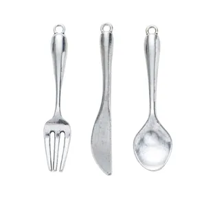 Vintage alloy cutlery pendant set featuring miniature fork, knife and spoon for DIY crafts