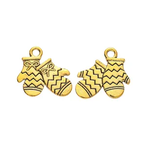 Detail of vintage zinc alloy Christmas mitten charms with bowknot and wavy texture